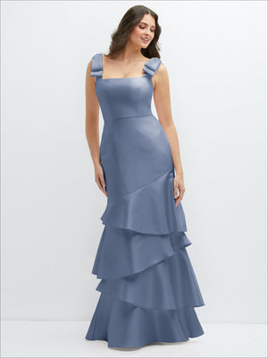 Bow-shoulder satin maxi dress in dusty blue with asymmetrical tiered skirt, front view