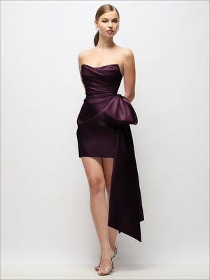 Burgundy strapless satin mini dress with gathered drape and long bow tail