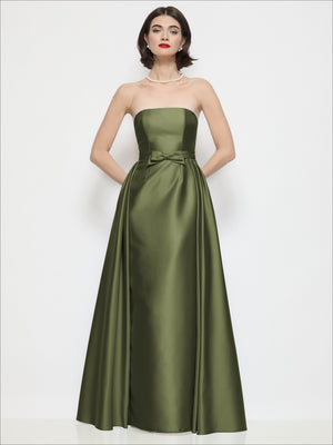 Strapless satin column dress in olive green with waist bow and draped overskirt
