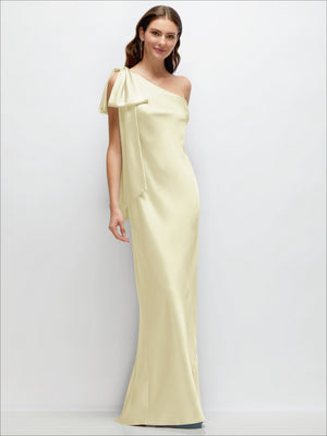 Champagne one-shoulder satin maxi dress with cascading shoulder bow, bias-cut fit