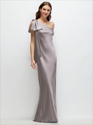 One-shoulder satin maxi dress with cascading shoulder bow, light gray.