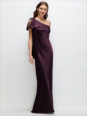 One-shoulder bias-cut satin maxi dress in plum with cascading shoulder bow