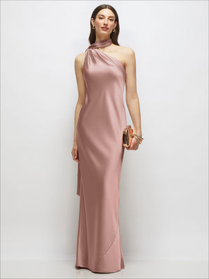 One-shoulder satin maxi dress in ballet pink with draped scarf neckline and long silhouette.