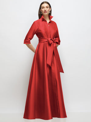 Red satin shirt dress gown with 3/4 sleeves, jeweled button front, and tied sash
