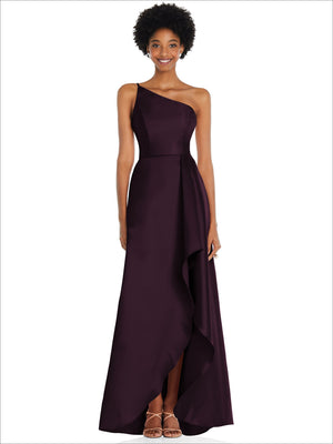 One-shoulder satin gown in deep plum with draped front slit and flowing skirt