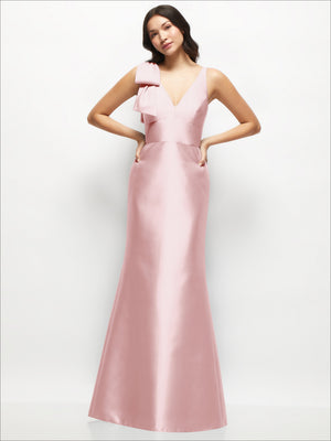 Blush satin trumpet dress with deep V neckline and one-shoulder cascading bow