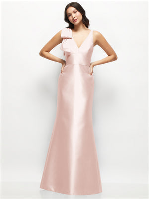 Blush satin trumpet dress with deep V neckline and one-shoulder cascading bow detail