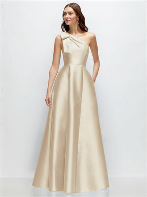 One-shoulder satin maxi dress in light beige with bow detail at the neckline.