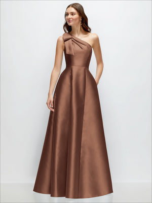 One-shoulder satin maxi dress in medium brown with bow detail at the neckline.