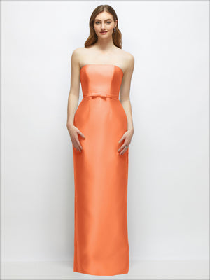Strapless satin column dress in coral orange with skinny belt and bow trim at waist