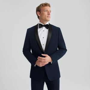 Men's navy tuxedo jacket with shawl lapel, single-breasted front and black bow tie