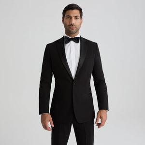 Men's black tuxedo jacket with peak lapels, front button closure, and satin trim.