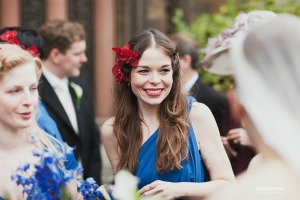 The sapphire blue dress contrasts perfectly with the vivid orchid in the bridesmaid's hair bridesmaid with red orchid in hair
