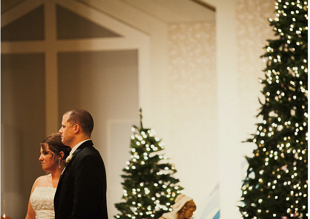 January wedding Couple with Christmas trees at January wedding