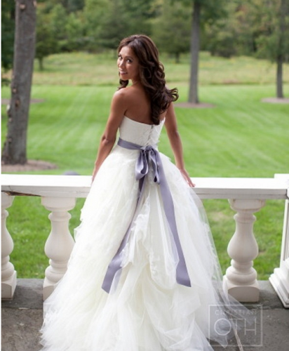 Via Style Me Pretty Bride in wedding dress with purple sash