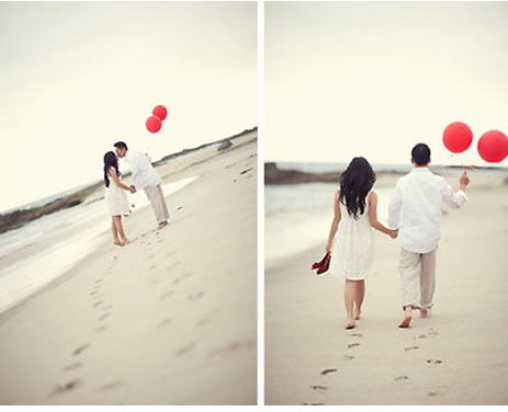 Image via Caroline Tran Photography couple walking along beach with red balloons for engagement photo shoot