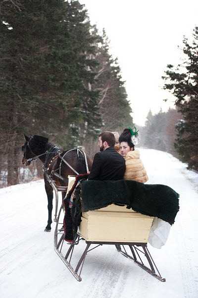 winter wedding styled shoot bride and groom in snow and carriage