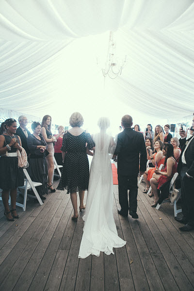 beach wedding bride and parents walking down aisle