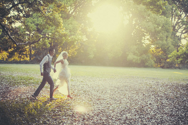 outdoor wedding bride and groom running